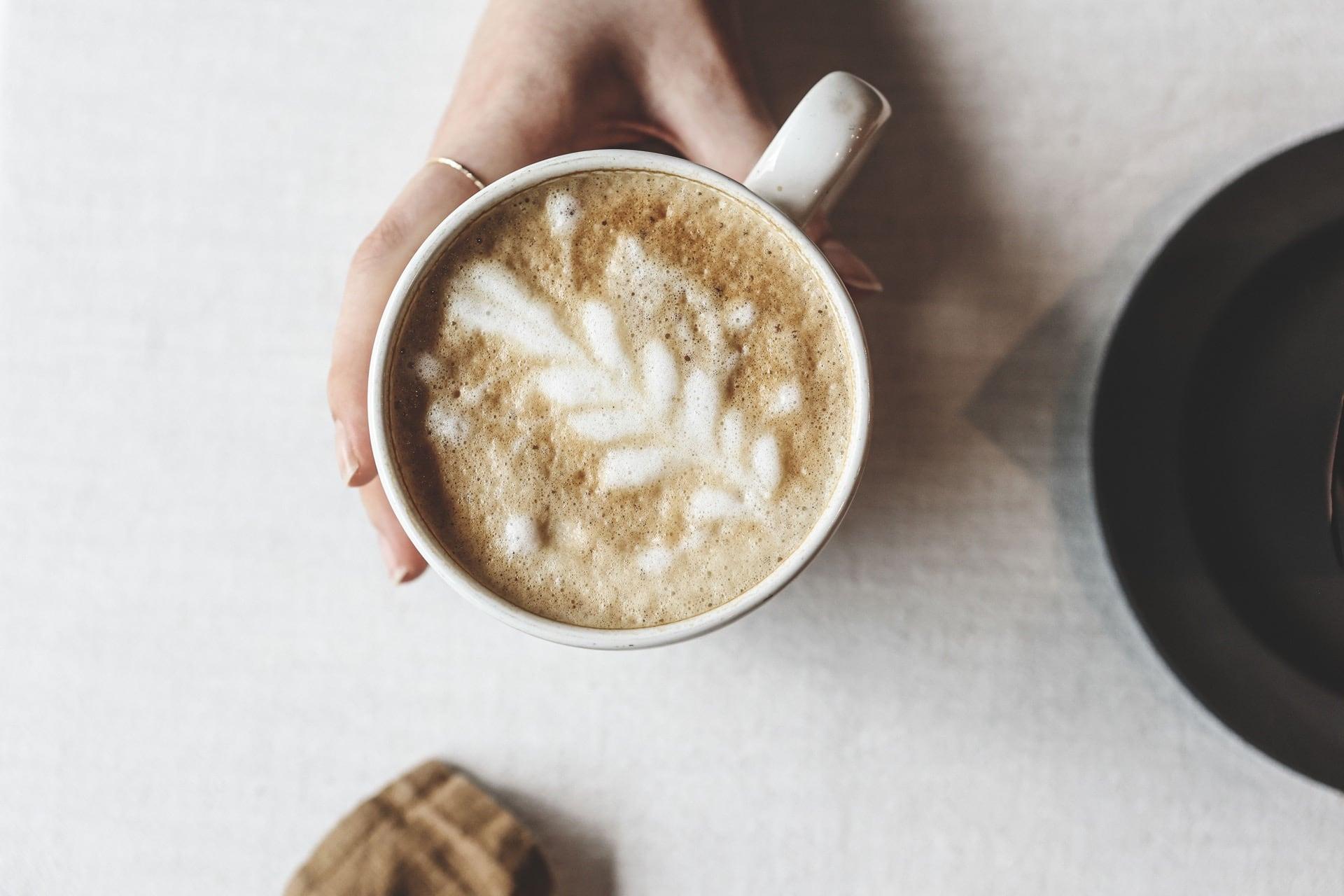 A customer holds a cup of coffee