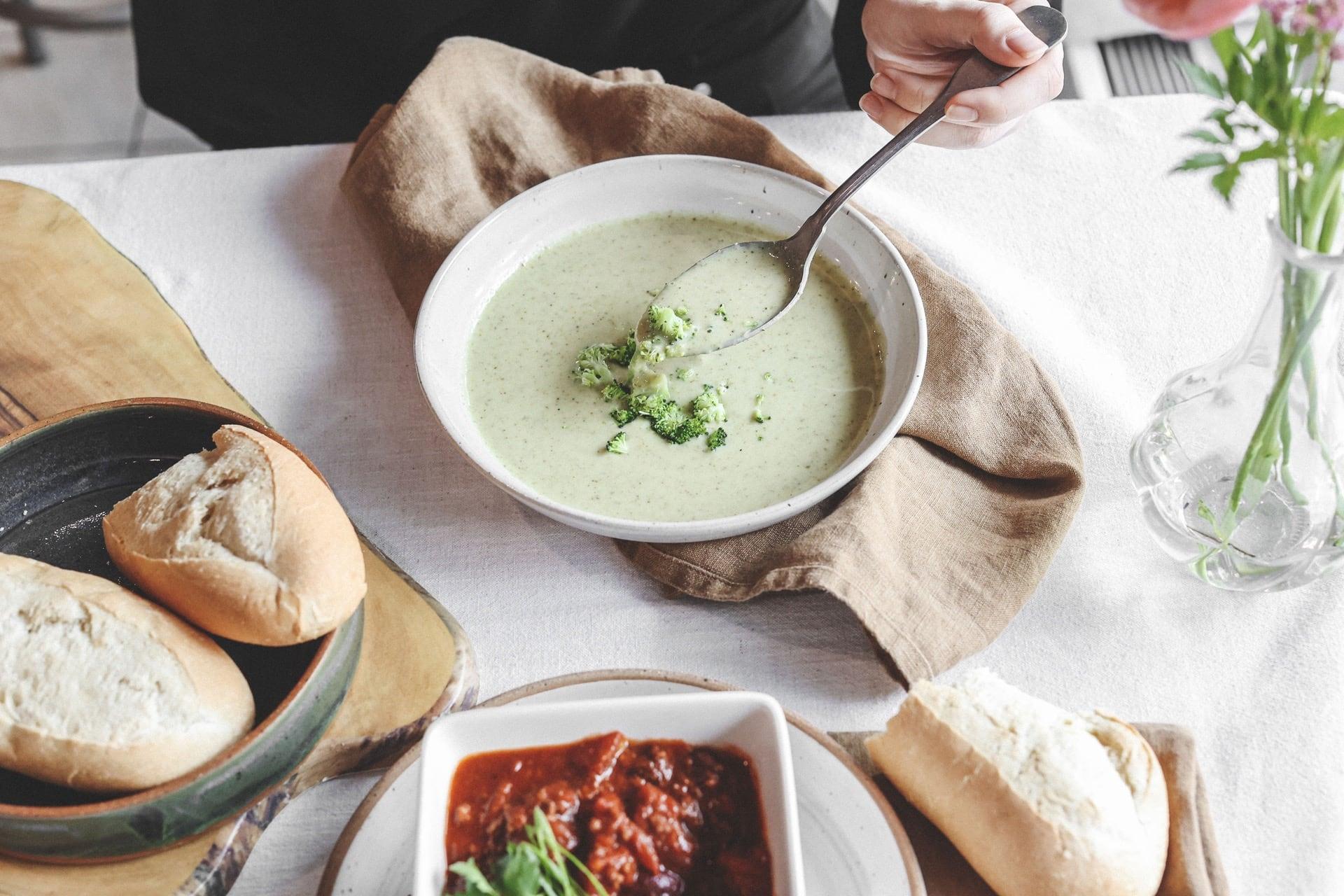 A customer eats some soup at the cafe